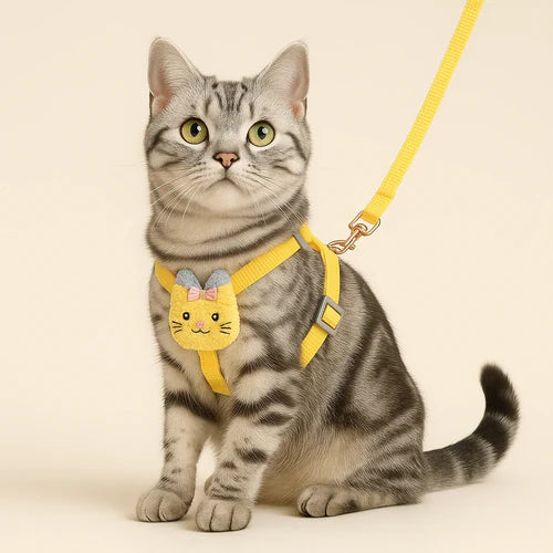Cat wearing a yellow harness with a cartoon design Adjustable Cat Harness & Leash Set – Plush Design for Kittens & Cats