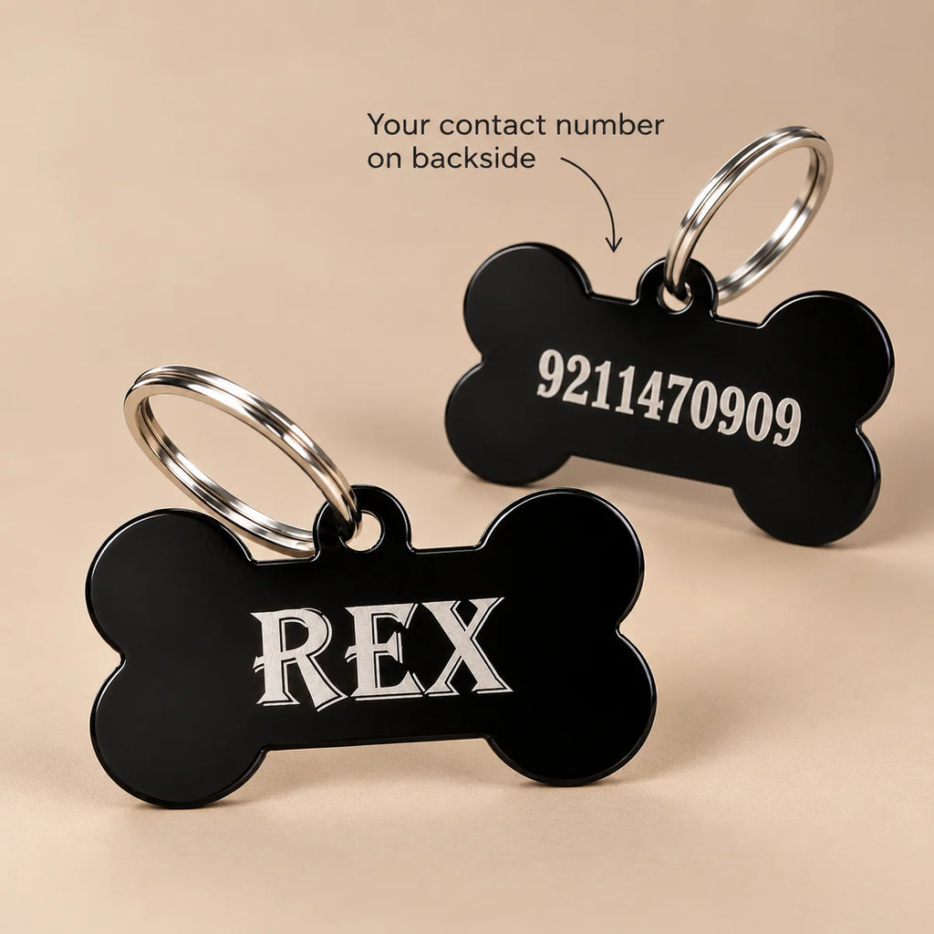 Front and back of a black bone-shaped dog name tag, showing REX on the front and an engraved contact number on the back